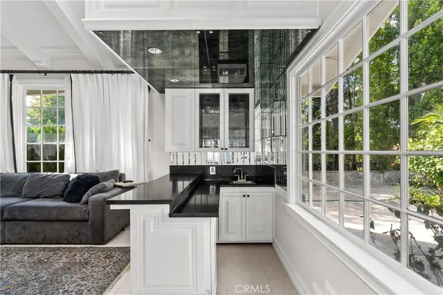a kitchen with granite countertop a sink and a granite counter tops and a large window