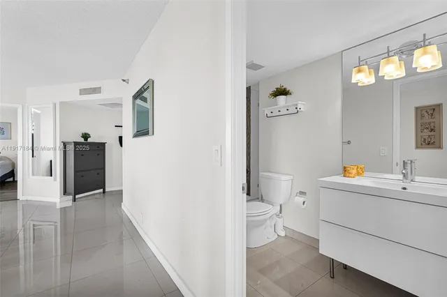 a view of bathroom with a sink toilet and a mirror