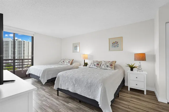 a bedroom with two beds and a table