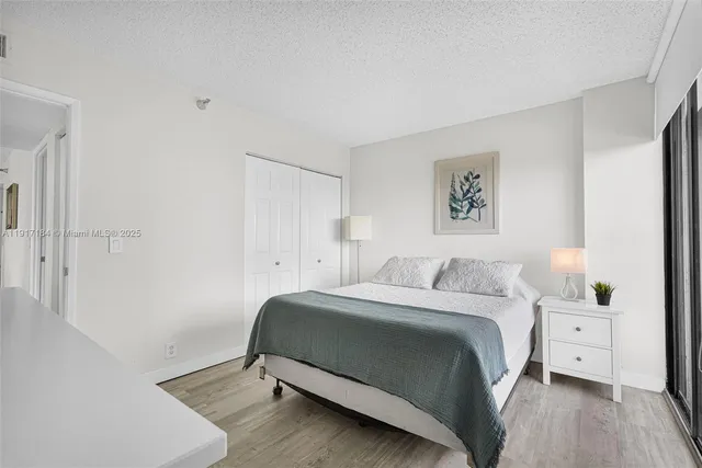 a bedroom with a bed and lamp