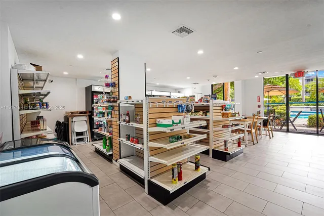 a kitchen with stainless steel appliances a stove a refrigerator a sink dishwasher and white cabinets with wooden floor