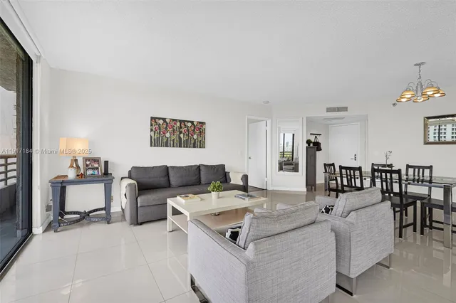 a living room with furniture and view of kitchen