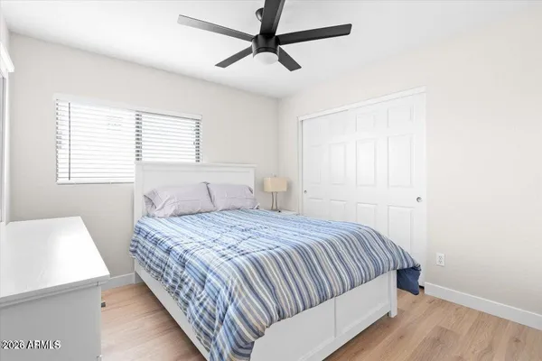 a bedroom with a bed and a window