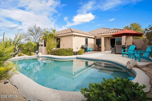 a view of a swimming pool with a patio