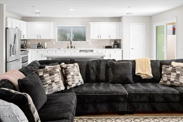 a living room with a couch and a kitchen island