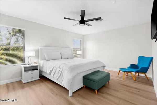 a bedroom with a bed and a chair