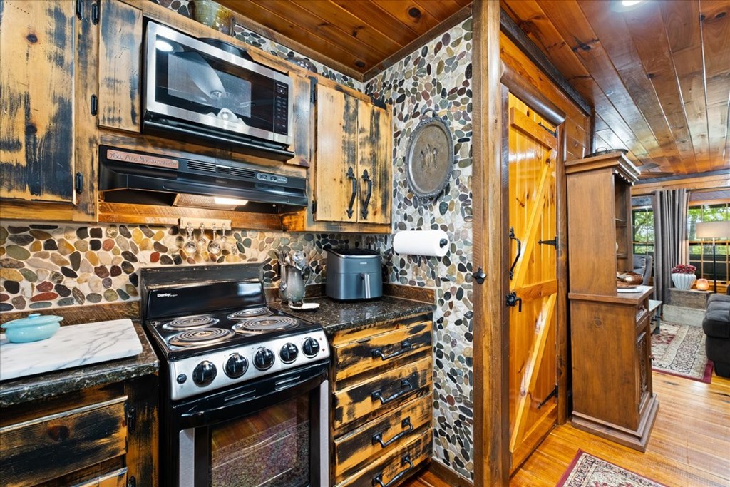 90 Mountain View Trail Blue Ridge, GA 30513 - Photo 11 of 43 a stove top oven sitting inside of a kitchen