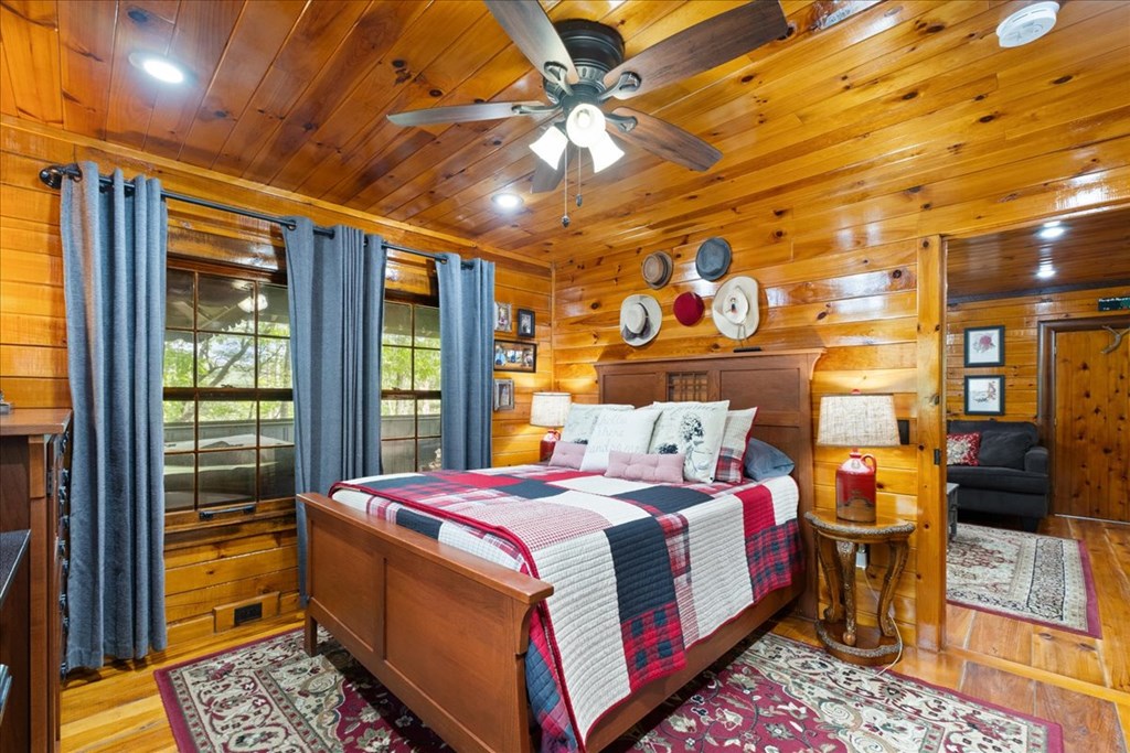 90 Mountain View Trail Blue Ridge, GA 30513 - Photo 20 of 43 a bedroom with a bed and a chandelier