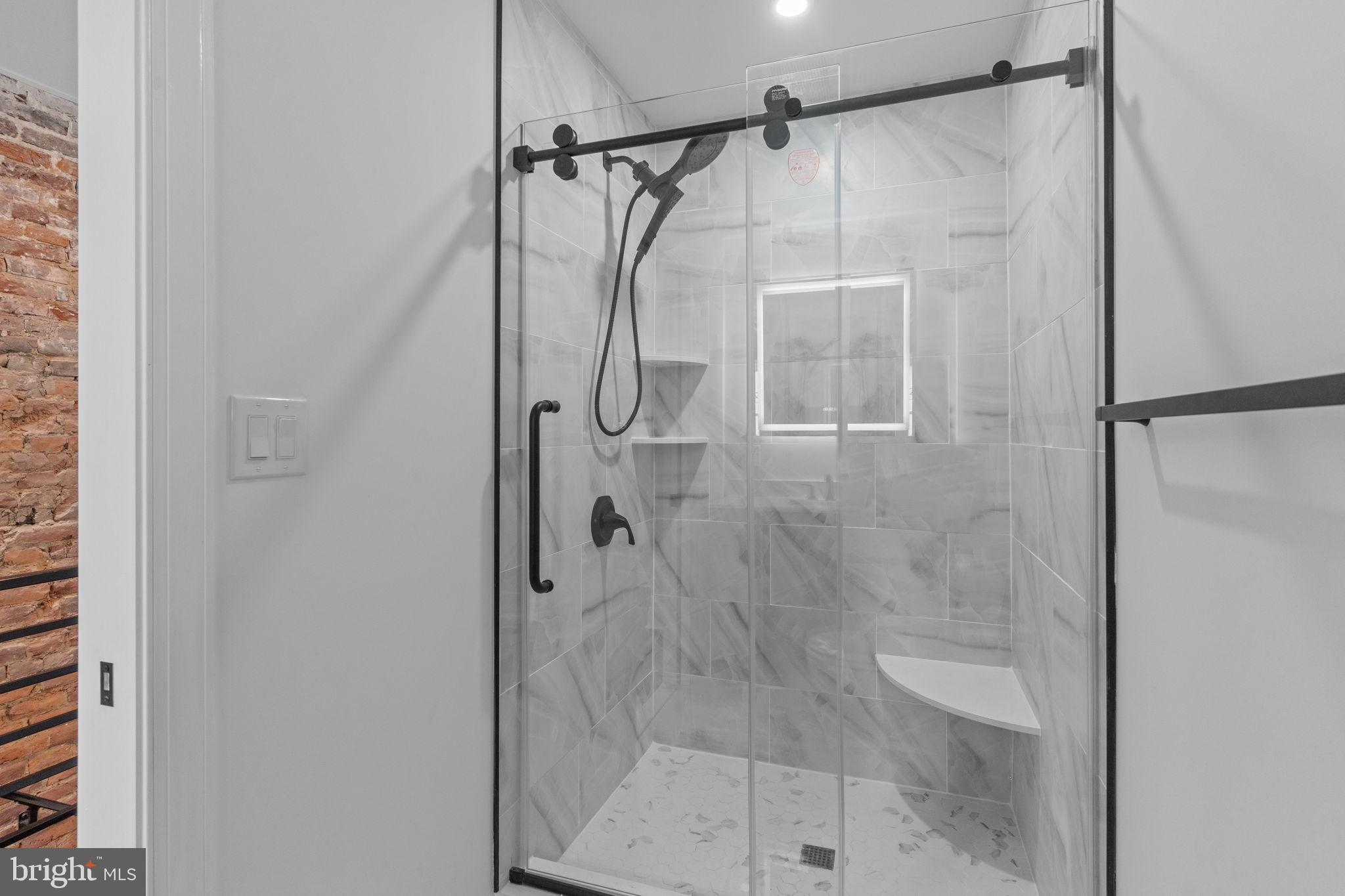 1307 Palethorp Street Philadelphia, PA 19122 - Photo 20 of 31 Sleek modern shower with elegant marble tiles.