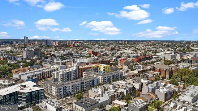 an aerial view of a residential apartment building with a yard