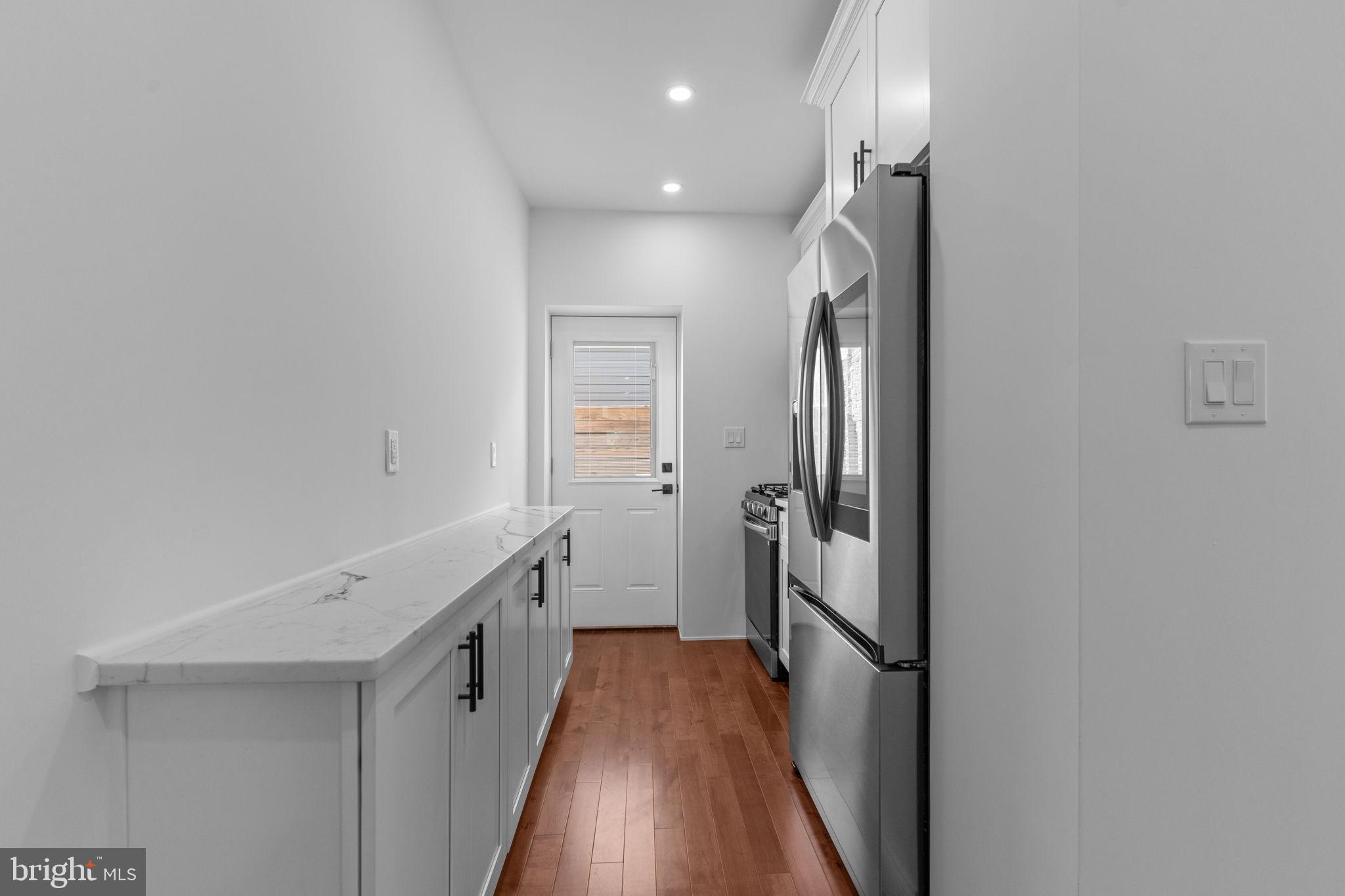 1307 Palethorp Street Philadelphia, PA 19122 - Photo 9 of 31 Sleek kitchen corridor with modern finishes.