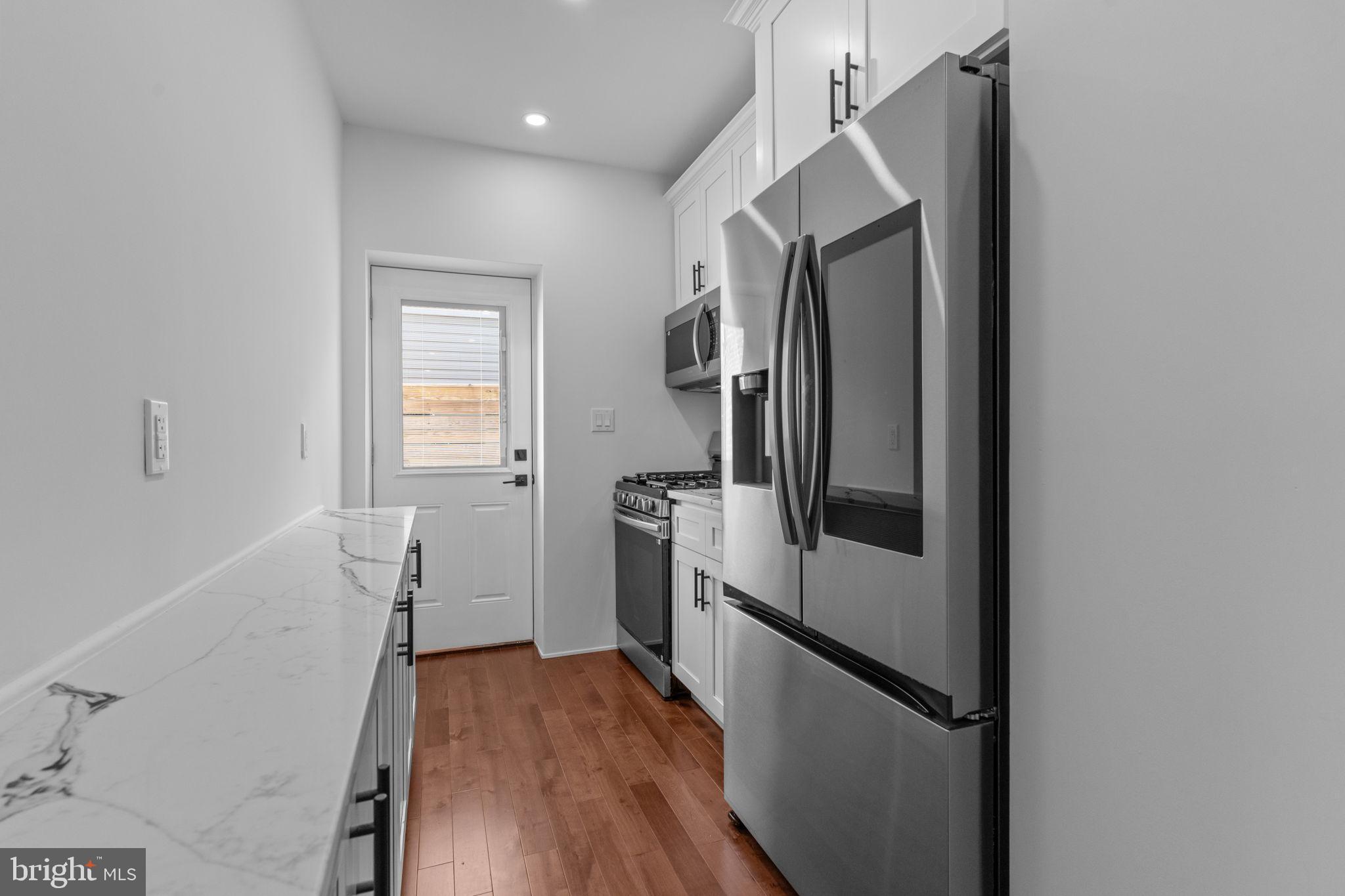 1307 Palethorp Street Philadelphia, PA 19122 - Photo 10 of 31 Sleek kitchen with modern finishes and light.