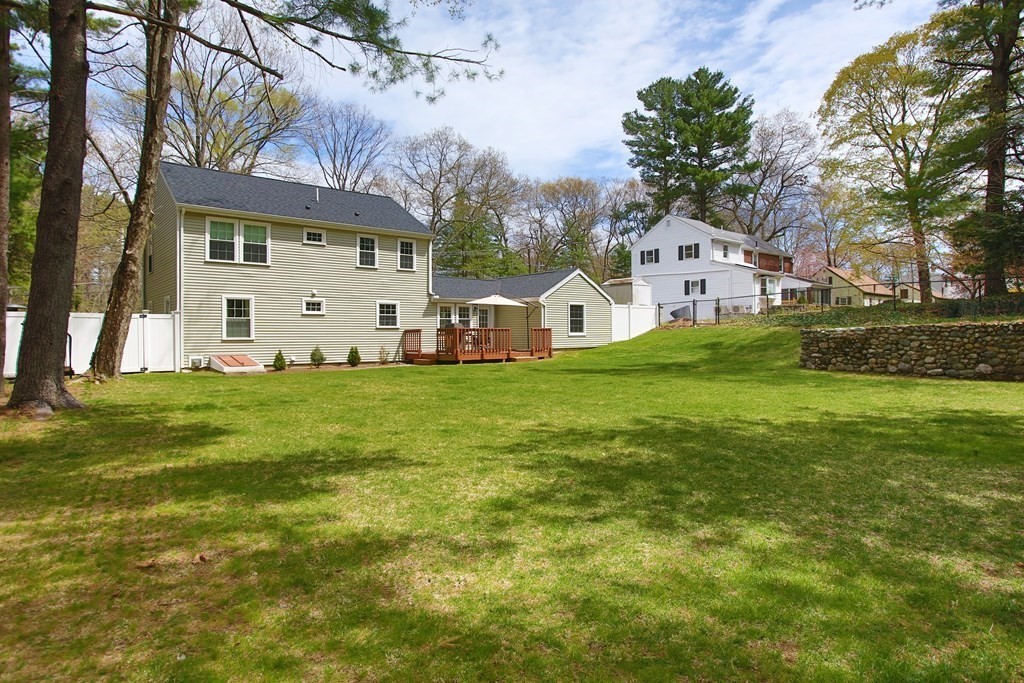 73 Moosehill Road Walpole, MA 02032 - Photo 2 of 21 a view of a white house with a big yard and large trees