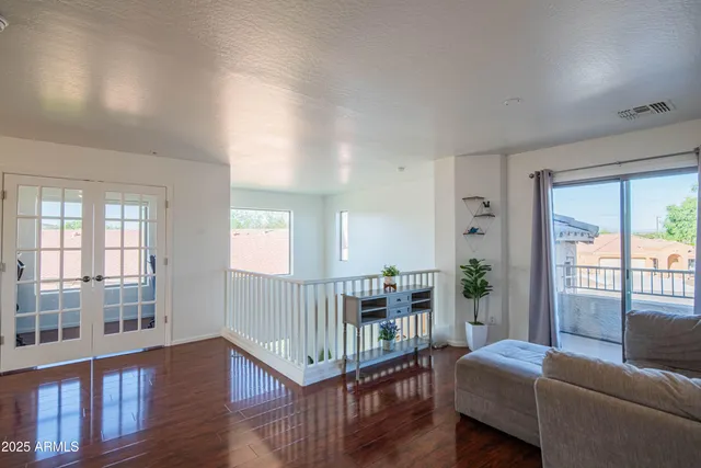 a living room with furniture and wooden floor