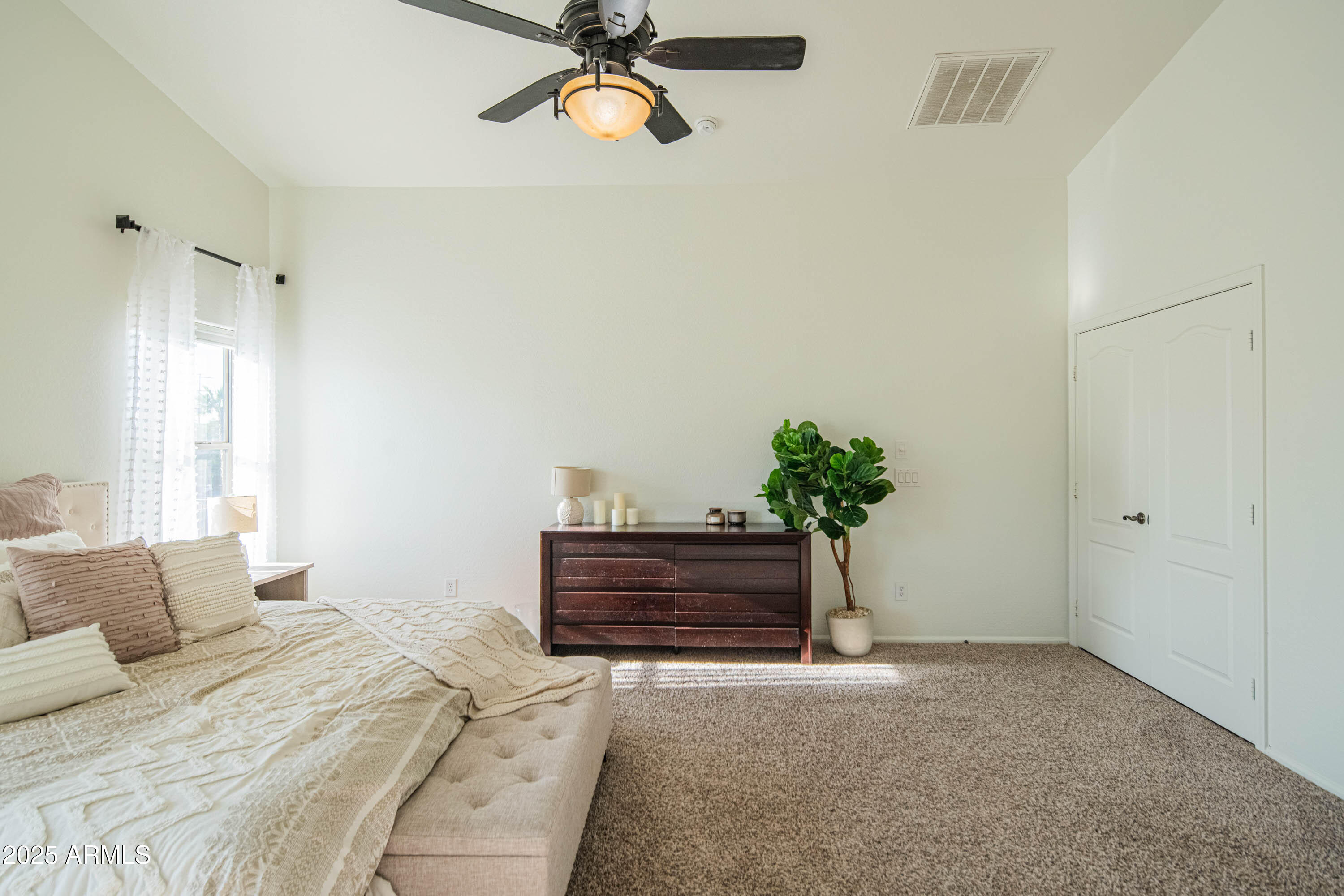 2831 East Jj Ranch Road Phoenix, AZ 85024 - Photo 16 of 32 a bed room with a bed and a potted plant