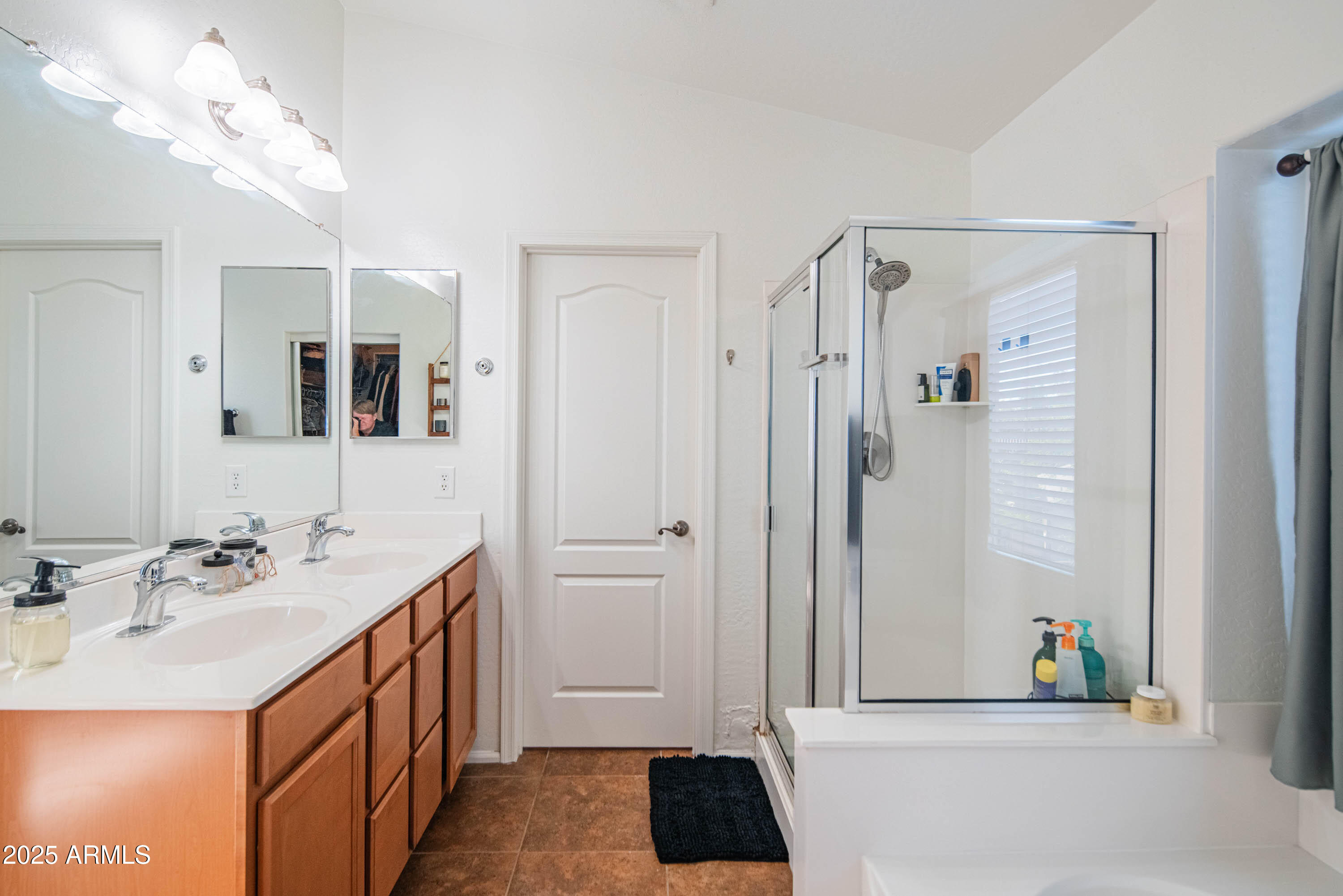 2831 East Jj Ranch Road Phoenix, AZ 85024 - Photo 18 of 32 a bathroom with a sink a mirror and a shower