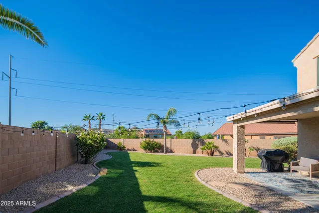 a view of a house with a yard and potted plants