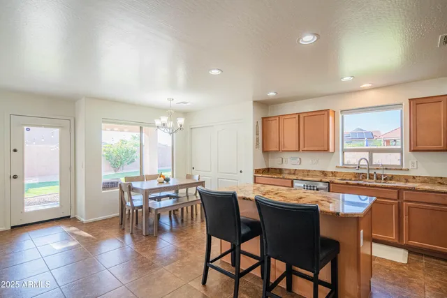 a dining hall with stainless steel appliances a table and chairs