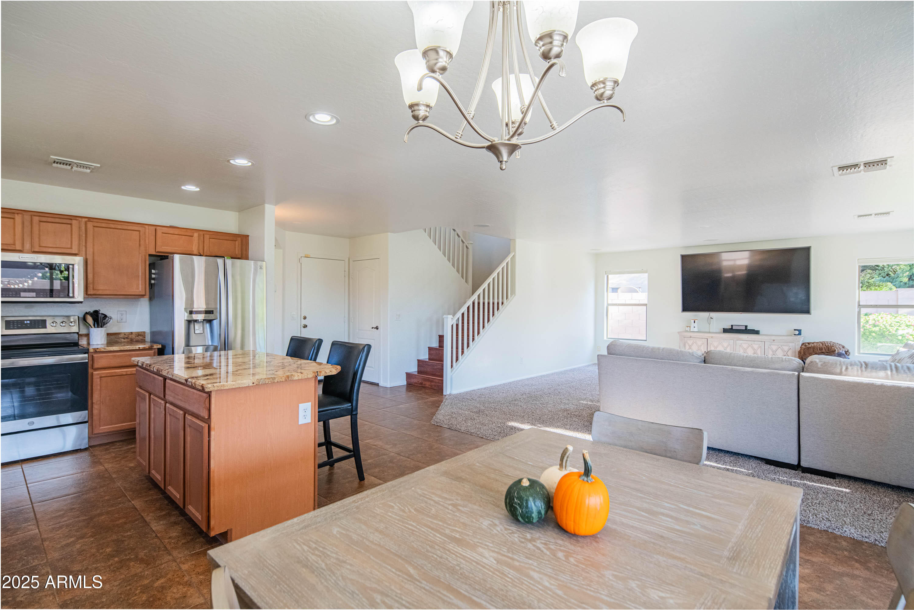 2831 East Jj Ranch Road Phoenix, AZ 85024 - Photo 31 of 32 a living room with stainless steel appliances furniture and a flat screen tv