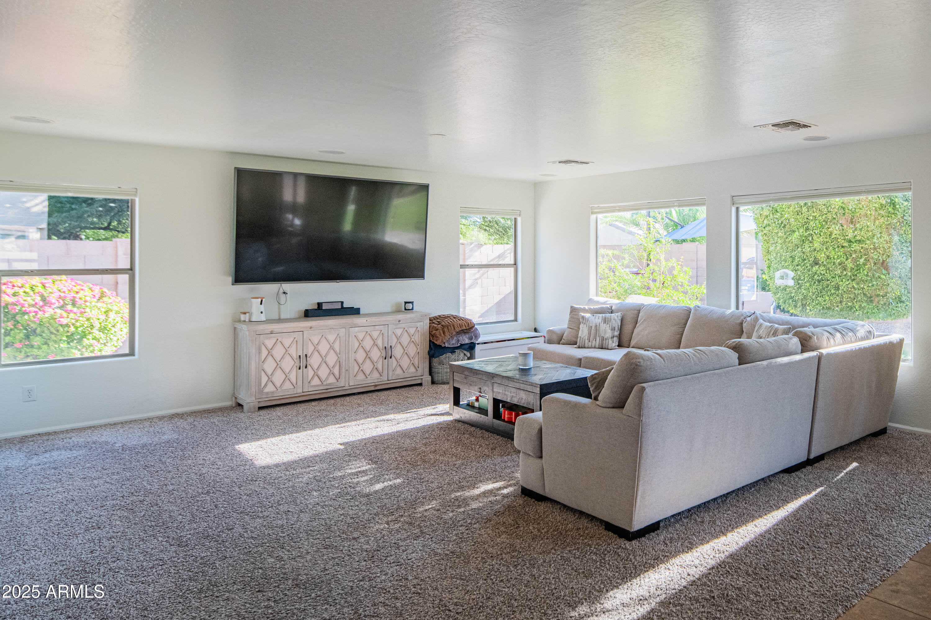 2831 East Jj Ranch Road Phoenix, AZ 85024 - Photo 7 of 32 a living room with furniture and a flat screen tv