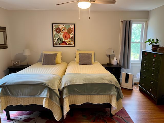 2306 Bedford Avenue Raleigh, NC 27607 - Photo 12 of 18 a bedroom with a bed and wooden floor
