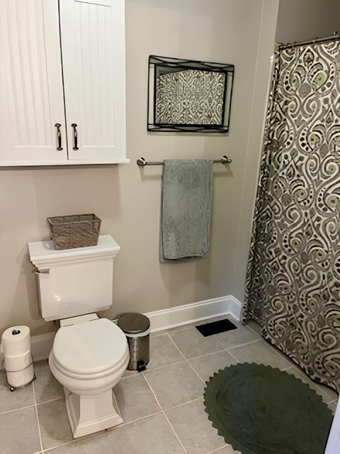 2306 Bedford Avenue Raleigh, NC 27607 - Photo 16 of 18 a bathroom with a toilet and a shower