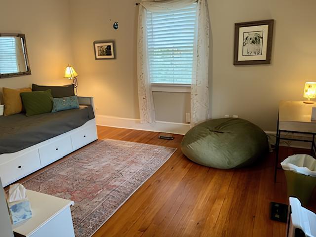 2306 Bedford Avenue Raleigh, NC 27607 - Photo 7 of 18 a living room with a bed and a dresser