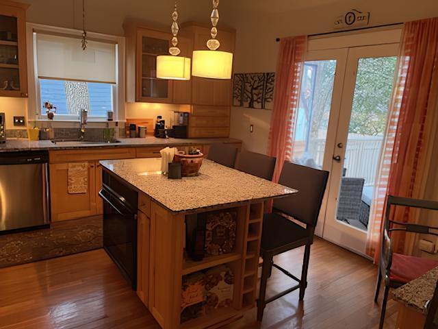 2306 Bedford Avenue Raleigh, NC 27607 - Photo 10 of 18 a kitchen with a kitchen island a sink dining table and chairs