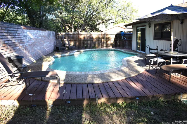 a white toilet sitting next to a bathroom sink and a mirror
