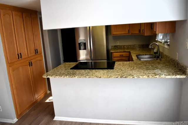 a kitchen with a refrigerator and a sink