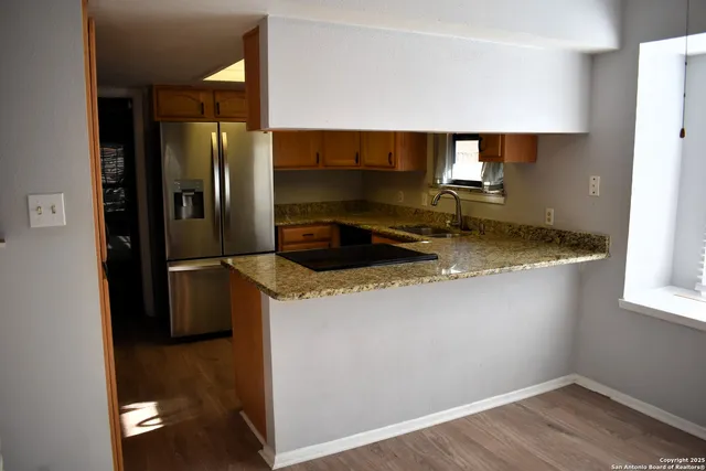 a kitchen with a refrigerator and a sink