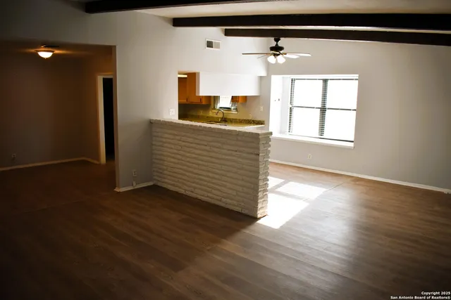 a view of a walk in closet and wooden floor