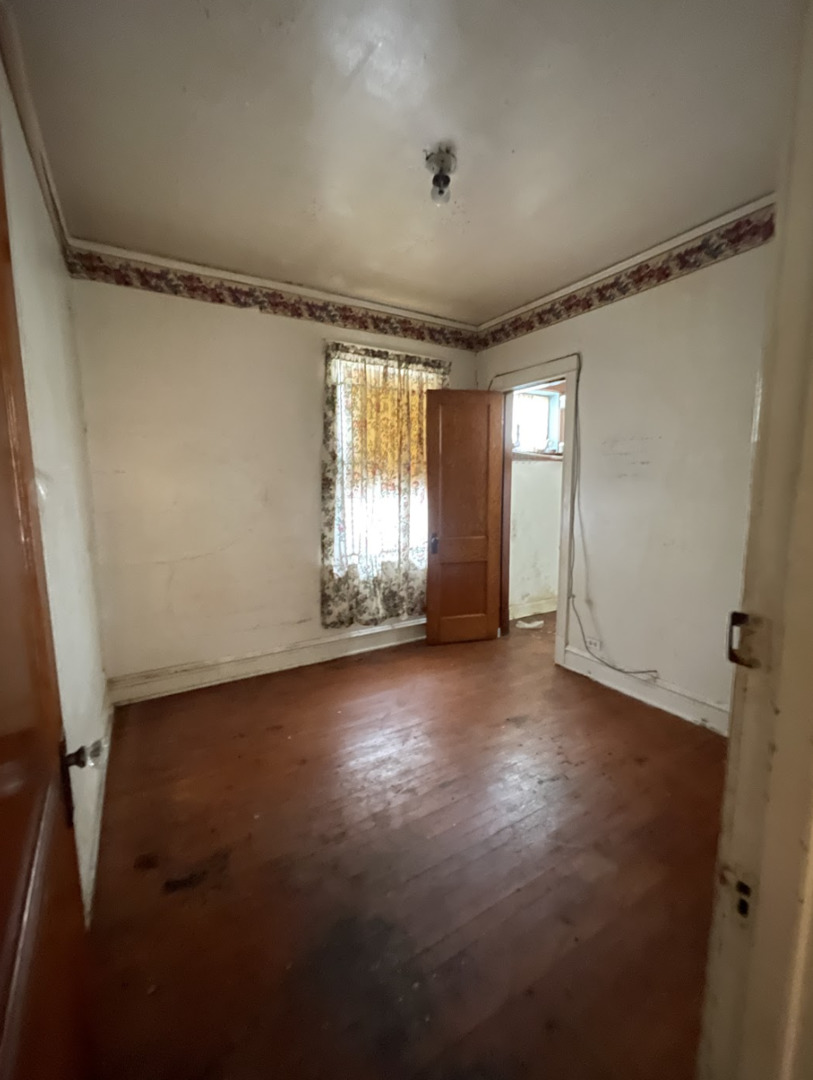 11548 South Normal Avenue Chicago, IL 60628 - Photo 3 of 14 a view of livingroom with window and hardwood floor