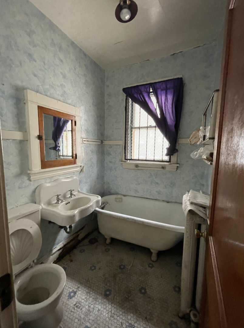 11548 South Normal Avenue Chicago, IL 60628 - Photo 6 of 14 a bathroom with a sink toilet and bathtub