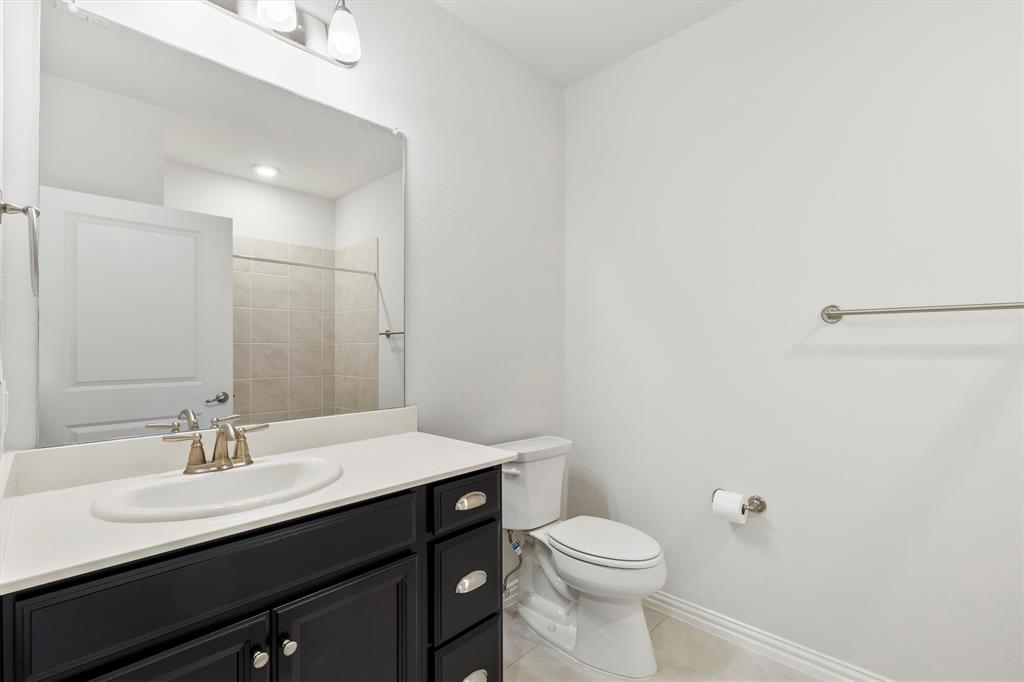 651 Watters Road, Unit 7202 Allen, TX 75013 - Photo 20 of 33 a bathroom with a sink a toilet and a mirror
