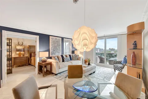 a living room with furniture a fireplace and a large window with garden view
