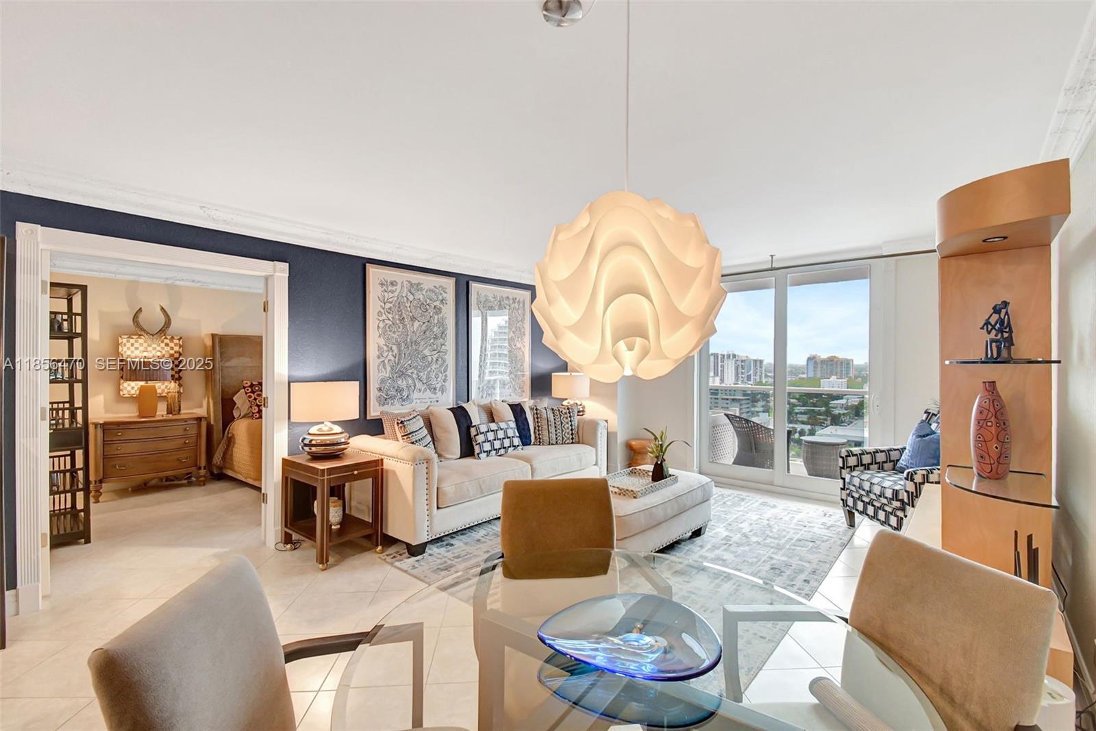a living room with furniture a fireplace and a large window with garden view