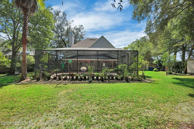 a view of a house with a yard and sitting area
