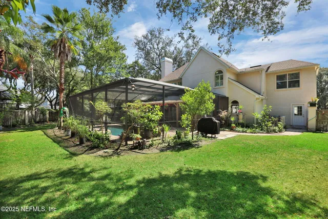 a view of a house with backyard sitting area and garden