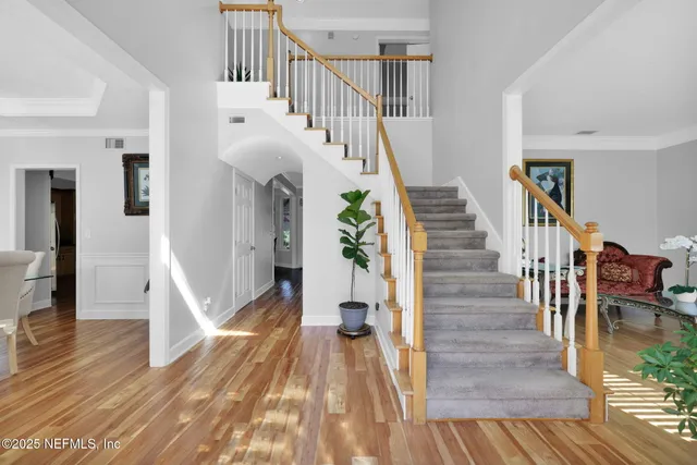 a view of entryway and hall with wooden floor
