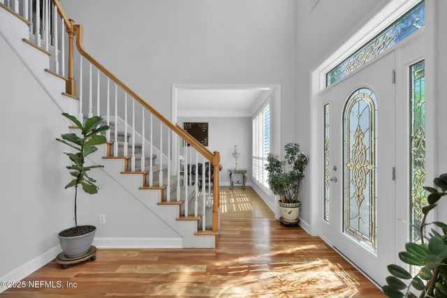 a view of an entryway with wooden floor and front door