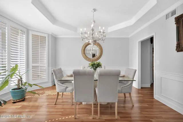 a view of a dining room with furniture window and wooden floor