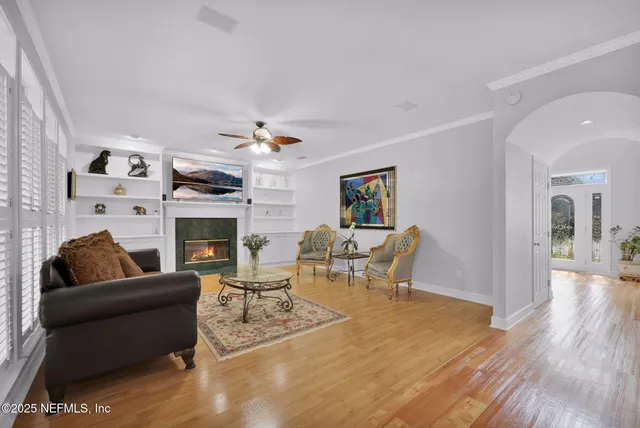 a living room with furniture a fireplace and a flat screen tv