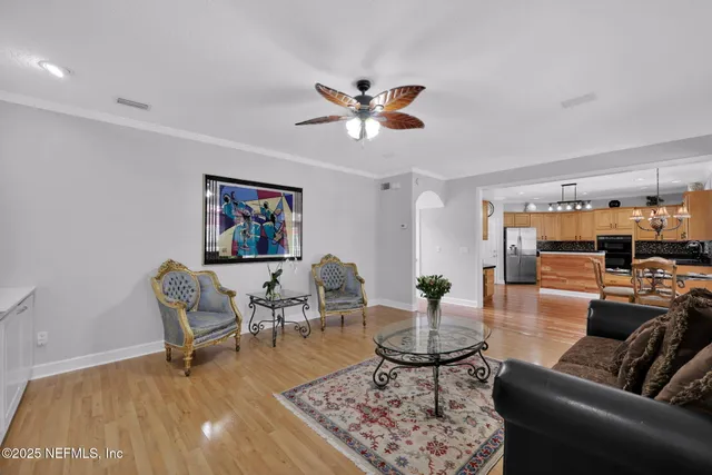 a living room with furniture a rug and a chandelier