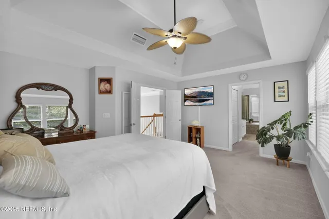 a bedroom with a bed and ceiling fan