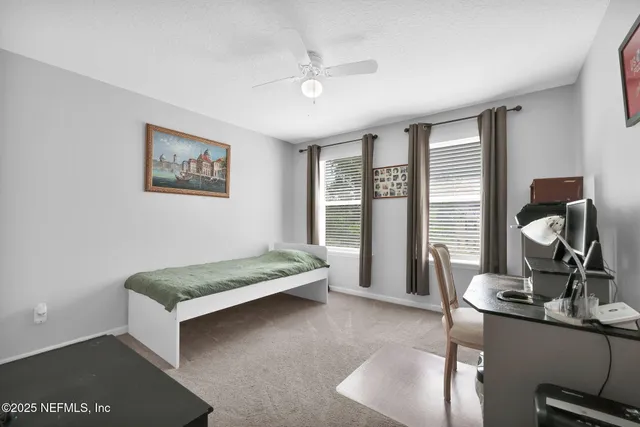 a living room with couch and a large window