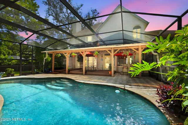 a view of a backyard with plants and a patio
