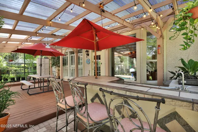 a view of a house with swimming pool and sitting area