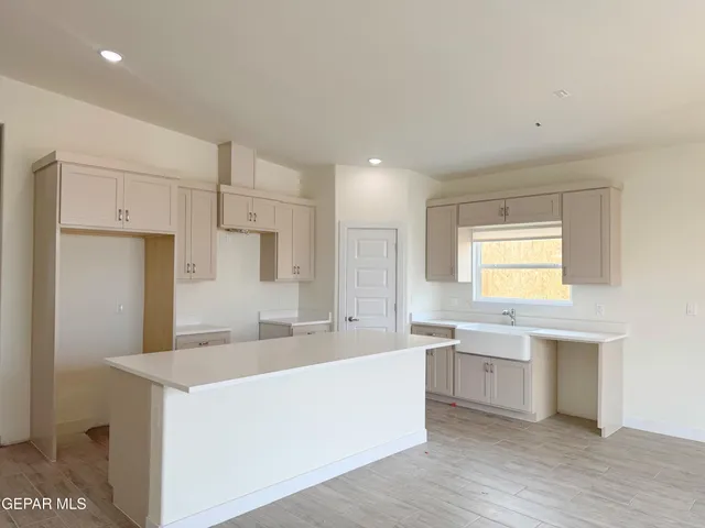 a spacious bathroom with a sink a mirror and a shower