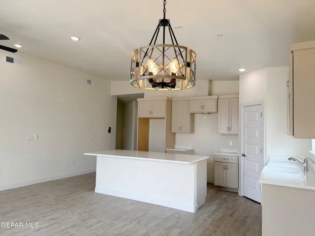 a kitchen with a sink cabinets and a window